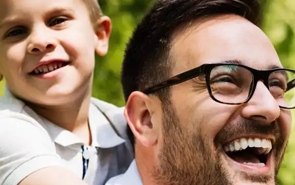 father-carrying-his-son-on-back-and-smiling-outdoors